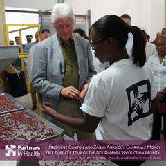 President Bill Clinton and a delegation of business representatives toured Partners In Health/Zanmi Lasante's Nourimanba: production facility in Corporant on March 10, 2013.  President Clinton listens as Zanmi Agrikol quality control manager Charmille Moncy describes the peanut shelling process.  Photograph by Rebecca E. Rollins / Partners In Health